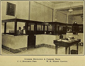 The inside of Mechanics and Farmers Bank in 1922, including bank president C. C. Spaulding Interior Mechanics & Famers Bank.jpg