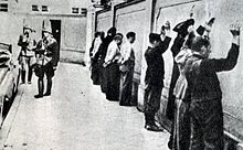 Detained civilians at the wall of the prison on Waly Jagiellonskie Street Internowani Waly Jagiellonskie.jpg