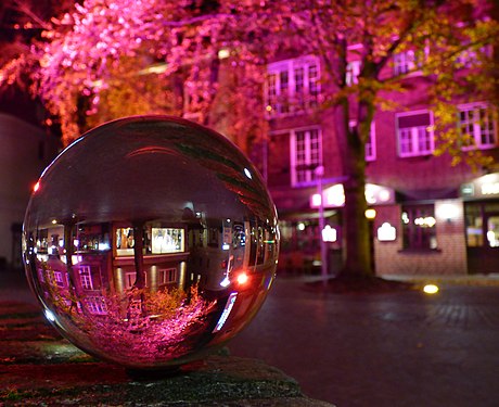 Glass sphere in front of a pink tree