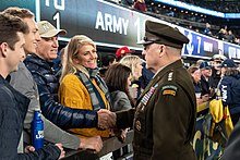 Milley shaking hands with a Navy fan before the 2021 Army-Navy football game Mark Milley MetLife Stadium 2021.jpg