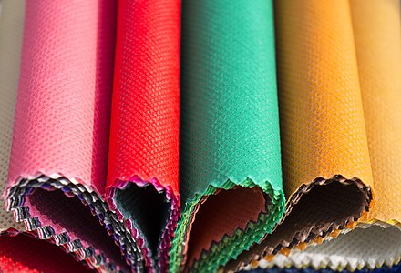 Multiple colored swatches of non-woven fabric