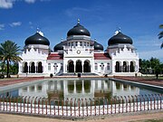 The Baiturrahman Grand Mosque in the center of Banda Aceh city, Aceh Province, Indonesia. The mosque was built (1879) in Dutch East Indies architectural style with the combination of occidental and oriental features. The mosque's stepped gables (trapgevel in Dutch) are reminiscent of Dutch Renaissance architectural style. Meuseujid Raya Baiturrahman, Aceh.jpg