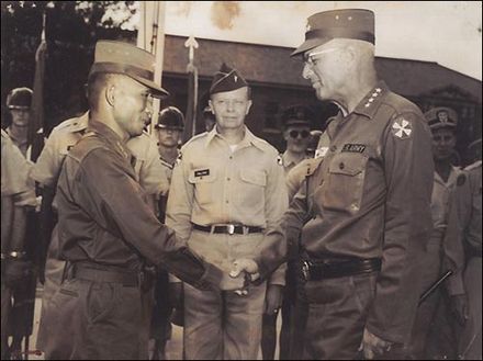 Park Chung-hee (left) shakes hands with General Guy S. Meloy after the May 16 coup. Park helped to enforce the "Base Community Clean-Up Campaign".[63][64]