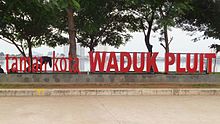A picture showing a park with red standing letters, Taman Kota Waduk Pluit
