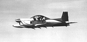 Peter Garrison test-flying the as-yet unpainted Melmoth in 1973. Yarn tufts on fuselage reveal air flow over wing. The horizontal tail was later moved to the top of the vertical tail. Peter Garrison Melmoth Test Flight.jpg