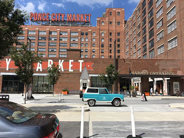 The entrance of Ponce City Market showing the large neon sign on the rooftop.