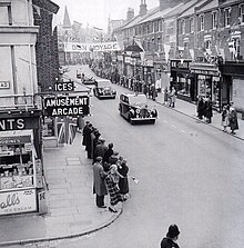 Rolls-Royce leads the way (1958): the Phantom IV state landaulette, carrying the Queen, with a Daimler state car following it. Queen Elizabeth II (6486594915).jpg