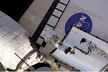 Astronaut John Olivas moves toward Atlantis' port OMS pod. STS117 Danny Olivas EVA3.jpg