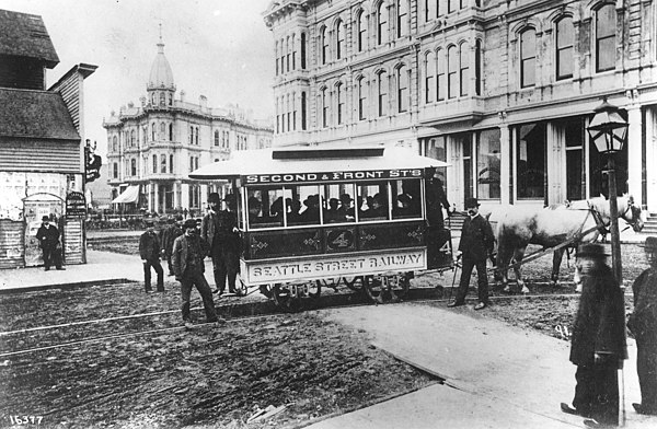 Seattle Street Railway's first streetcar at Occidental Avenue and Yesler Way with Mayor John Leary and city officials in the fall of 1884