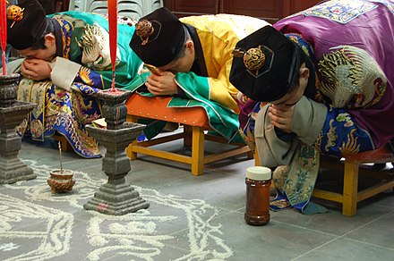 Priests of the Zhengyi order bowing while officiating a rite at the White Cloud Temple of Shanghai.