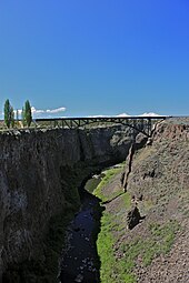 The Three Sisters mountains visible over the Crooked River Railroad Bridge north of Terrebonne