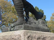 Feet of sculpted soldier, with sculpted barbed wire under them