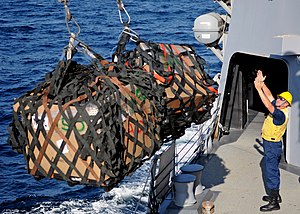 US Navy 120127-N-ZF681-080 Boatswain's Mate 2nd Class Michael Ringleman manages supplies aboard the guided-missile destroyer USS Halsey (DDG 97) du.jpg