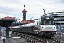 A Talgo Series 8 trainset departs Portland Union Station with the engineer controlling the train from the cab located inside the power car.