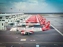 A lineup of AirAsia Airbus A320s at KLIA Terminal 2 in September 2022 21-SEP-2022 - 3K684 KUL-SIN (A320 - 9V-JSJ) (04).jpg