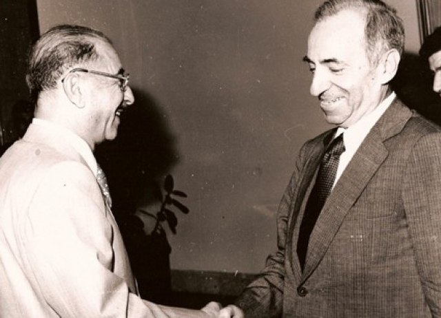 Ahmed Hassan al-Bakr (left), the Regional Secretary of the Iraqi Ba'ath, shaking hands with Michel Aflaq, principal founder of Ba'athist thought, in 1