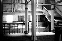 Central staircase of the derelict building, 1992 Collegiate derelict interior 1992.jpg