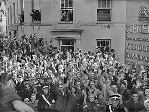 Crowds of people gathered outside the General Assurance Corporation building in St Peter Port, Guernsey to welcome the British Task Force sent to liberate the island from German occupation, 10 May 1945. D24590 Crowds of people gathered ouside the General Assurance Corporation building in St Peter Port, Guernsey to welcome the British Task Force sent to liberate the island from German occupation, 10 May 1945. D24590.jpg