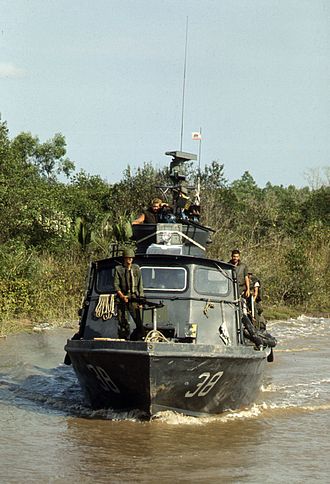 A Mk 18 grenade launcher in use on a Patrol Craft Fast (on top of the dual .50 M2 Browning machine guns) Fast Patrol Craft PCF-38 on Cai Ngay canal 1970.jpg