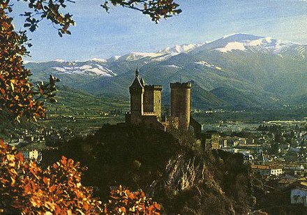 Castle of Foix towering above the town, with the Pyrenees behind.