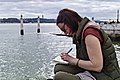 Girl writing near the Tagus River (41037455652).jpg