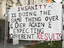 A banner posted in the area Insanity Occupy Sign.jpg