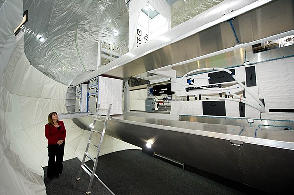 NASA Deputy Administrator Lori Garver views the inside of a full-scale mockup of Bigelow Aerospace's Space Station Alpha.