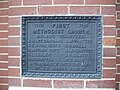 Plaque set into church, like a foundation stone.