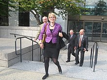 Sinema walking up stairs and smiling to the camera
