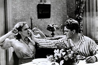 A controversial scene in which Tom (James Cagney) angrily smashes a half grapefruit into his girlfriend's face (Mae Clarke) Mae Clarke and James Cagney.jpg