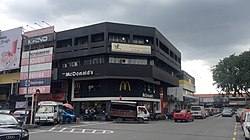 A busy corner in one of SS2's commercial zones, with a corner McDonald's shophouse outlet next to traffic.
