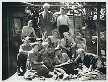 Merric and Doris Boyd at home, Open Country, with their family, complete, in 1943, gathered for a photograph by Albert Tucker whose companion Joy Hester, lazes on one arm to the right. Merric Boyd and Doris Boyd's family and friends, Open Country, Murrumbeena.jpg