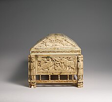 End view of the casket showing the detailed carvings and the guards on the corners.