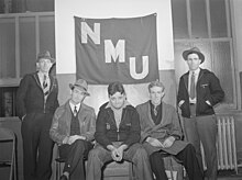 Seamen in hiring hall, National Maritime Union banner, New York City, December 1941. Photograph: Arthur Rothstein NMU-members-1941.jpg