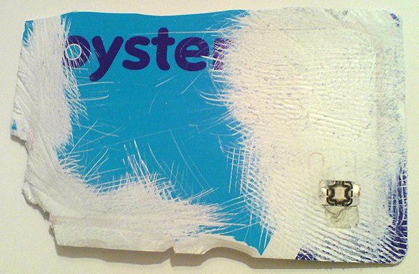 A damaged Oyster card, revealing the microchip in the lower right corner and the aerial running around the perimeter of the card.