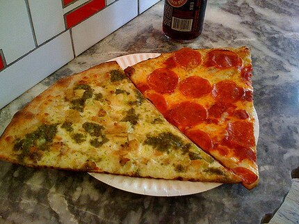 Slices of New York-style pizza, chicken pesto on the left, pepperoni on the right