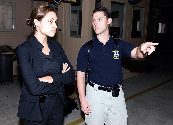 Rosario Dawson receiving a safety briefing from Special Agent Patrick McGee while researching her role as an AFOSI agent.