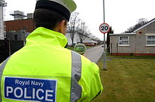 A member of the Royal Navy Police carrying out a vehicle speed check at HMS Sultan in Gosport, Hampshire. Royal Navy Police Monitoring Traffic Speed in Shore Establisment MOD 45153697.jpg