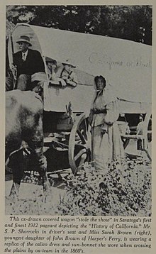 Sarah Brown, 1912, recreating the conditions of their trip to California. (Dress and covered wagon are replicas.) Sarah Brown and a replica "prairie schooner".jpg