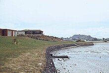 Newly constructed seawall and housing in Farm Cove in 1973 Sea wall, Farm Cove, Pakuranga, 1973 (cropped).jpg