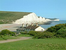 The South Downs meets the sea at the Seven Sisters Seven Sisters cliffs and the coastguard cottages, from Seaford Head showing Cuckmere Haven (looking east - 2003-05-26).jpg