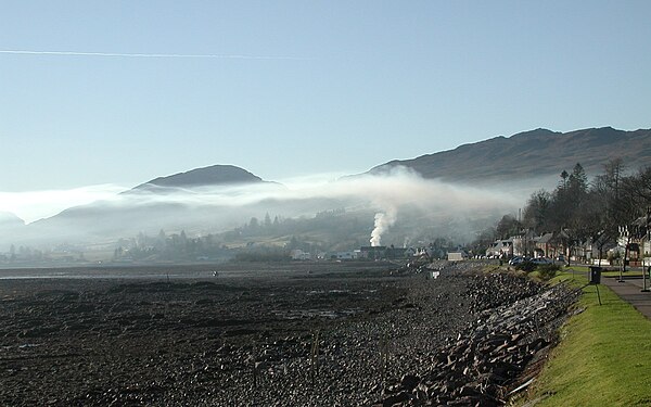 Smoke rising in Lochcarron, Scotland, is stopped by an overlying natural low-level inversion layer of warmer air (2006).