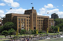 A contemporary image of the precinct with the MCA building centre, First Fleet Park at left and partially obscured, and promenade.