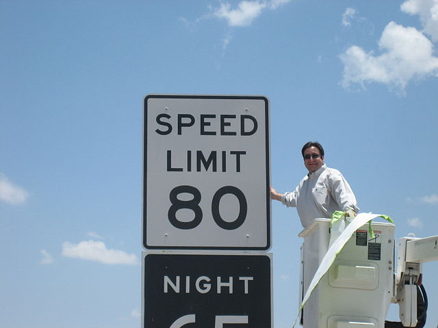 Texas State Rep. Pete Gallego unveiling a new 80 mph (130 km/h) speed limit sign on I-10 near Fort Stockton