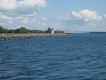 View of Prescott's shoreline looking east towards the Galop Rapids. Fort Wellington was built to protect the head of the Galop Rapids. The breakwater and lighthouse - panoramio.jpg