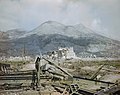 The ruins of Cassino, May 1944- a wrecked Sherman tank and Bailey bridge in the foreground, with Monastery Ridge and Castle Hill in the background. TR1799.jpg