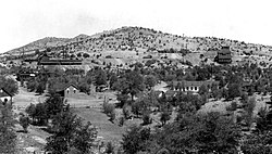 Mowry mine and mining camp, mill at right, smelter at left, circa 1909.