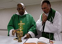US Navy 070921-N-6278K-004 Father Joseph Harris, left, a Roman Catholic priest in Trinidad and Tobago, celebrates mass with Lt. Cmdr. Paul Evers.jpg