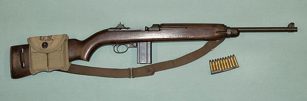 WW II M1 carbine with a magazine pouch mounted on the stock that held two spare 15-round magazines and 10 .30 Carbine rounds on a stripper clip