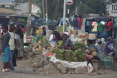 Women at evening market in the street, selling food and fruits (Tanzania)